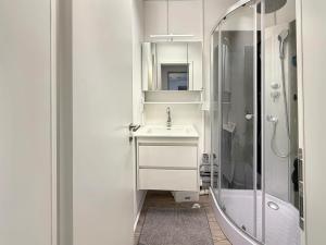 a white bathroom with a sink and a shower at Gruppenloft Stuttgart Kicker & 14 Gäste in Stuttgart