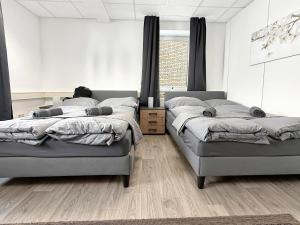 a bedroom with two beds and a window at Gruppenloft Stuttgart Kicker & 14 Gäste in Stuttgart