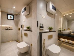 a bathroom with a toilet and a sink at Hotel Preeti Residency Delhi in New Delhi