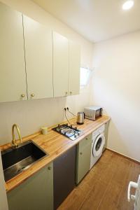 a kitchen with a sink and a stove top oven at Casa Camellia in Kobuleti