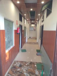 an empty hallway in a building with a hallway at Hotel Shivay in Haridwār