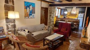 a living room with a couch and chairs and a kitchen at El Racó de les Grases in Horta de San Joan