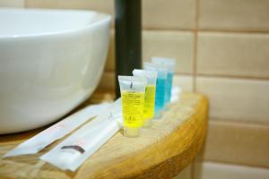 a counter with toothbrushes and toothpaste on it at Sky Glass Cottage in Kʼveda Chʼkhutunetʼi