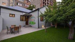 a house with a painting on the side of it at Garden Hostel 16 in Yerevan