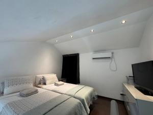 a bedroom with a bed and a flat screen tv at Royal Park Eilat 138 duplex in Eilat +38 photos