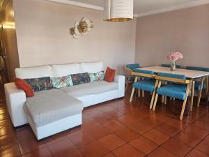 a living room with a couch and a table at Muralha da Barca Apartamentos -Fique no centro do Porto junto a ponte D-Luis IRNAL nº13939 Al,5848 Al, 6419 AL-Chamada para a rede móvel nacional in Porto +73 photos