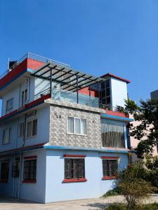 a white building with scaffolding on top of it at Le Petit Paradis Nepal Terrace & Mountain View in Pātan