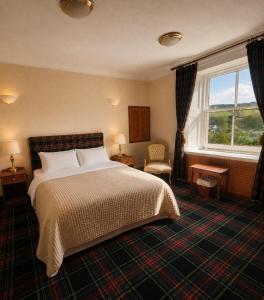 a hotel room with a bed and a window at Loch Ness Lodge Hotel in Drumnadrochit