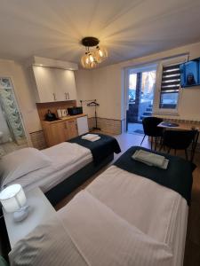 a hotel room with two beds and a kitchen at Biały Port in Rajgród