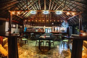 a restaurant with tables and chairs in a room at The Tranquilo Lodge, Adult Only, All meals included in Drake