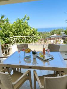 a table with a tray of food and wine glasses at Villa Arkadi in Tragaki