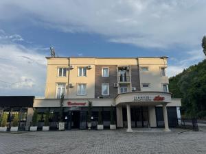 a building with a hotel on top of it at Hotel Lux in Mitrovica