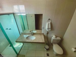 a bathroom with a sink and a toilet at Pousada Pedra Branca in Corinto