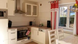 a kitchen with a sink and a stove top oven at Villa Hilde in Oy-Mittelberg