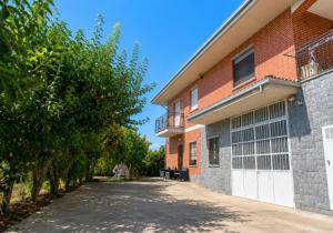 a house with a driveway next to a building at Villa Marie in Alpignano