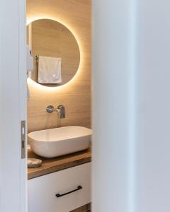 a bathroom with a sink and a mirror at Oceanfront Oasis in Borsh +76 photos