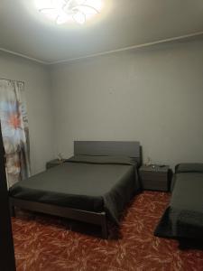 a bedroom with a bed and two night stands at Villa Marie in Alpignano