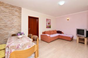 a living room with a couch and a table at Vila Mia in Donji Štoj