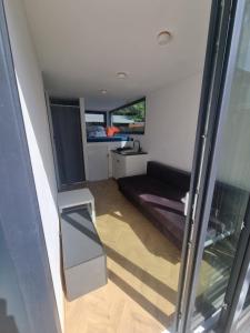 a small room with a couch and a bed at MAZI HOUSE Jastarnia in Jastarnia