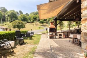 a patio with a pizza oven next to a building at Caserio Urikosolo in Bilbao