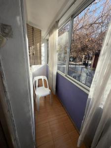 a white chair in a room with a window at Casa LYON in Barraquero