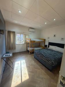 a bedroom with a bed and a table in it at Casa LYON in Barraquero