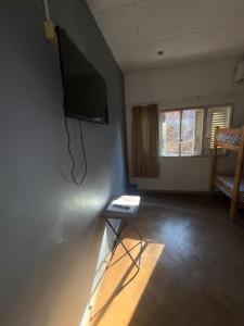 a room with a flat screen tv on a wall at Casa LYON in Barraquero