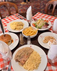a table topped with plates of food and french fries at Hôtel Restaurant Chez Henriette in Phalsbourg +5 photos