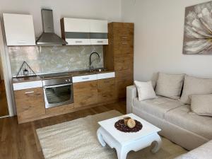 a living room with a couch and a kitchen at Stella in Šibenik