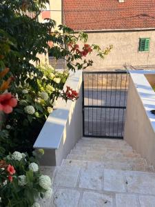 a stairway with a gate and some flowers at Stella in Šibenik