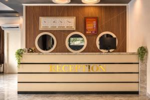 a reception area of a hotel with round mirrors at Hawaii Suite Beach Hotel in Alanya +54 photos