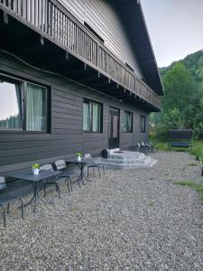a patio with tables and chairs in front of a building at Садиба ВидНа in Kvasy