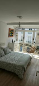 a bedroom with a bed and a large window at casa Chloe in Ourense