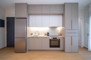 a kitchen with white cabinets and a sink at Anemi Residence in Chios +44 photos