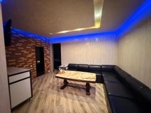 a living room with a couch and a table at Israel Ori Hotel in Yerevan