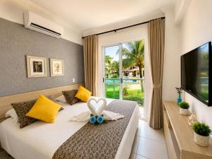 a bedroom with a bed with a heart decoration on it at Apto. Palm Beach, 300M Beach Park in Aquiraz