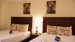 a hotel room with two beds and a statue on the wall at Bardo INN Hotel in Granada