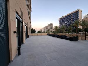 a large patio with couches on the side of a building at Costa Royal Resort in Villajoyosa