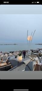 a rendering of a beach with tables and chairs at Welcome by Elida in Platamonas