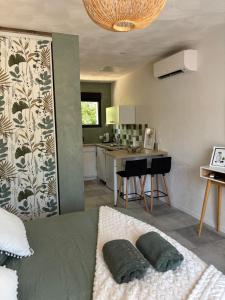 a bedroom with a bed with two pillows on it at Les Gîtes W''elles''come in Cotignac