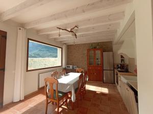 a kitchen with a table and chairs in a room at casa LHort in Benisili
