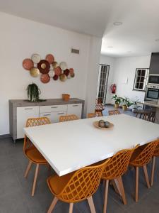 a kitchen with a white table and chairs at Casa 56 in Sardoal