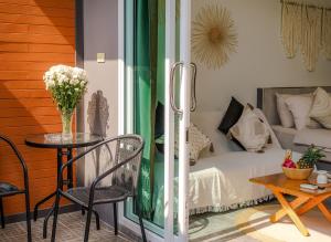 a room with a bed and a table and a couch at Charming Condo - 2mn ZenBeach - Heart of Srithanu - 4K SmartTV in Ko Kong Nui
