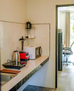 a kitchen with a counter top with a microwave at Charming Condo - 2mn ZenBeach - Heart of Srithanu - 4K SmartTV in Ko Kong Nui
