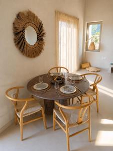 a dining room table with two chairs and a mirror at Cabana Retreat in Agia Effimia