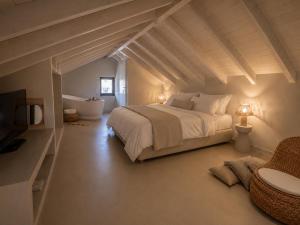 a bedroom with a large bed and a bathroom at Cabana Retreat in Agia Effimia