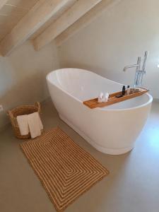 a white bath tub in a bathroom with a rug at Cabana Retreat in Agia Effimia +37 photos