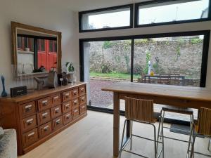 a kitchen with a table and a large window at loft with a garage feel in Périers