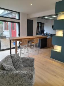a living room with a couch and a large table at loft with a garage feel in Périers