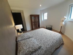 a bedroom with a bed and two lamps and a window at loft with a garage feel in Périers